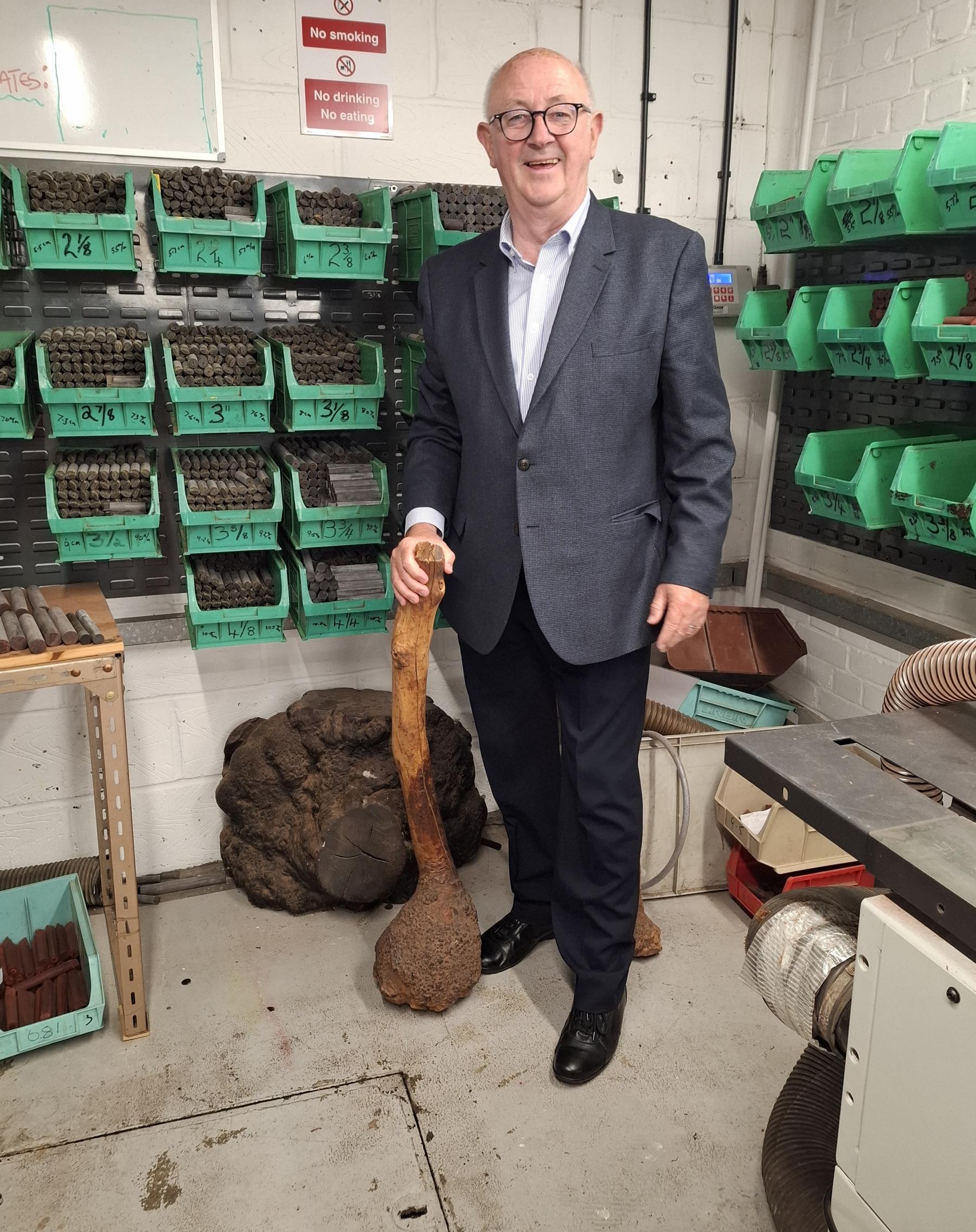 Holding a small briar root, next to a full mature root Walthamstow